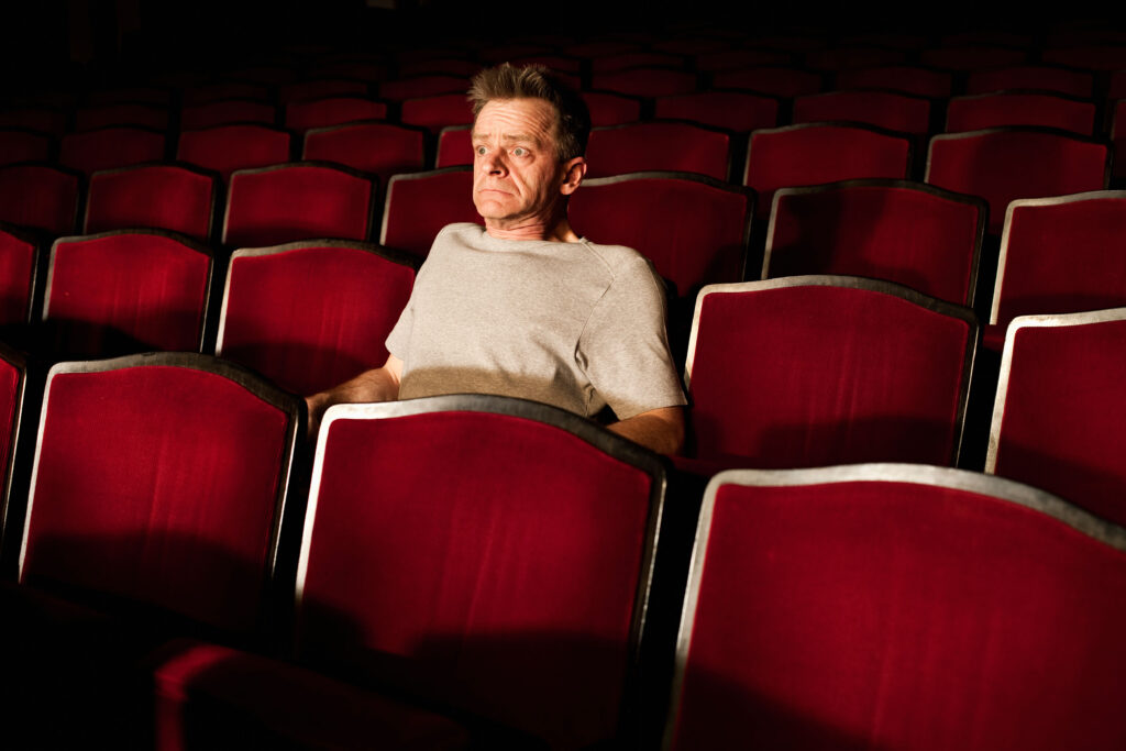 portrait of spectator watching theatre play